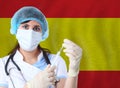 Research of viruses in laboratory concept with Scientist woman with test tube Coronavirus or COVID-19 against Spain flag Royalty Free Stock Photo