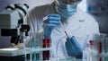 Researcher conducting blood test at modern medical laboratory, health care