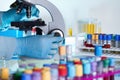 Researcher examining a sample under a microscope in the laboratory workbench Royalty Free Stock Photo