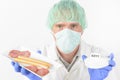 Researcher with food and preservatives Royalty Free Stock Photo