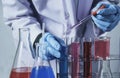 Researcher with glass laboratory chemical test tubes with liquid for analytical , medical, pharmaceutical and scientific research Royalty Free Stock Photo