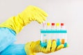 Researcher hands in rubber gloves is conducting chemical experiments in laboratory