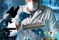 researcher holding tray with tube test for analysis in laboratory