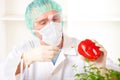 Researcher holding up a GMO vegetable Royalty Free Stock Photo