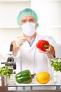 Researcher holding up a GMO vegetable in the lab Royalty Free Stock Photo