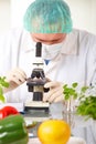 Researcher holding up a GMO vegetable in the lab Royalty Free Stock Photo