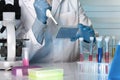 Researcher pipetting samples in microplates in the laboratory