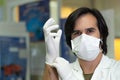 Researcher putting white nitrile surgical gloves