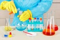 Researcher in rubber gloves is conducting chemical experiments in laboratory