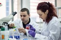 Researcher or scientist or doctoral student pours red and green