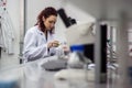 Researcher or scientist or doctoral student pours red and green