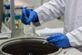 Researcher or scientist or phd student working in a biotechnology laboratory sampling DNA in a test tube with centrifuge Royalty Free Stock Photo