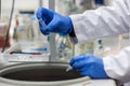 Researcher or scientist or phd student working in a biotechnology laboratory sampling DNA in a test tube with centrifuge Royalty Free Stock Photo