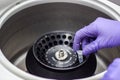 Researcher or scientist or PHD student working in a biotechnology laboratory sampling DNA in a test tube with centrifuge