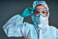 Researcher wearing hazmat protective suit and safety goggles