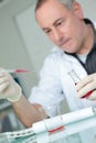 Researcher at work in laboratory with blood pipette