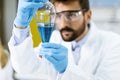 Researcher working with blue liquid at separatory funnel Royalty Free Stock Photo