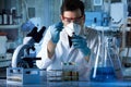 Researcher working in the laboratory dropping samples of liquid Royalty Free Stock Photo