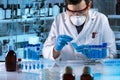 Researcher working with sample of blue fluid in tube for analysis in the science lab Royalty Free Stock Photo