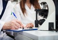 Researchers taking notes in a laboratory