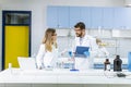 Researchers working with blue liquid at separatory funnel Royalty Free Stock Photo