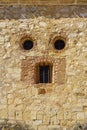 resemblance of face in an old stone house facade, eyes and mouth. Pedraza, Segovia