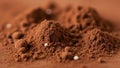 Resembling cocoa is mounded on a surface. Small, spherical white elements appea Royalty Free Stock Photo