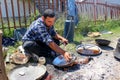 RESEN, MACEDONIA. MAY 18 , 2016- Young traveling artisan retinning old copper dish in village of Carev Dvor,Resen, Macedonia. Af