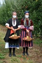 RESEN, MACEDONIA. 27 SEPTEMBER 2020 - Girls wearing protective masks in traditional clothes posing with apples during festival