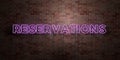 RESERVATIONS - fluorescent Neon tube Sign on brickwork - Front view - 3D rendered royalty free stock picture