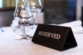 Reserve table in the restaurant. There is a sign on the table with the word Reserve. Royalty Free Stock Photo