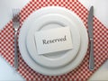 Reserved card on a restaurant table setting. Top view. Mock up.
