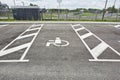 Reserved disable parking sign on asphalt road surface Royalty Free Stock Photo