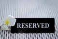 Reserved metal black plate in a restaurant. Reserved metal plate On the white table. vintage photo processing. close up of a Royalty Free Stock Photo