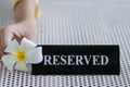 Reserved metal black plate in a restaurant. Reserved metal plate On the white table. vintage photo processing. close up of a Royalty Free Stock Photo