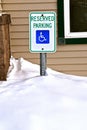 Reserved Parking Handicapped sign in a snow bank Royalty Free Stock Photo