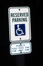 Reserved parking sign for disabled at night Royalty Free Stock Photo