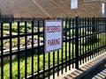 Reserved parking sign in front of a fence Royalty Free Stock Photo