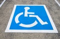 Reserved parking sign for handicapped. Disabled parking space with white blue painted sign of handicapped parking spot Royalty Free Stock Photo