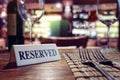 Reserved sign on restaurant table with bar background Royalty Free Stock Photo