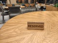 Wooden reserved sign in restaurant on table