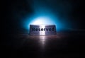 Reserved sign on the table. A tag of reservation placed on the wood table. Metal tag with reservation on dark. Reserved table in a Royalty Free Stock Photo