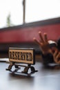 Reserved sign on a wooden table in a local Japanese restaurant during lunch time. Royalty Free Stock Photo