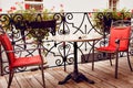 Reserved table with red chairs. Cafe terrace in small European city Royalty Free Stock Photo