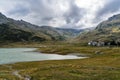 Reservoir lake in the Italian Alps near mountain pass SplÃ¼gen with big mountain range and italian mountain village