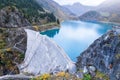 Reservoir lake and water dam in French Alps to produce hydroelectricity, sustainable development using renewable energy and