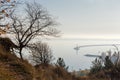 Reservoir from steep coast overgrown with trees in morning haze Royalty Free Stock Photo