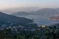 The reservoir under the blue sky and white clouds is surrounded by mountains and forests Royalty Free Stock Photo