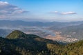 The reservoir under the blue sky and white clouds is surrounded by mountains and forests Royalty Free Stock Photo