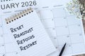 Reset, readjust, refocus, restart, inspirational checklist text in notebook with January 2026 calendar Royalty Free Stock Photo